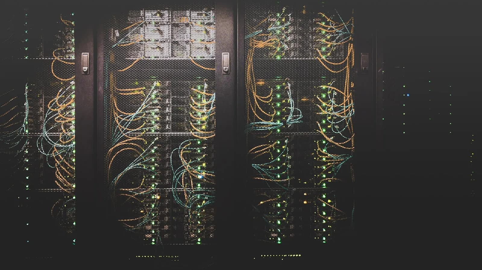 A data centre aisle with fibre cabling running through server racks