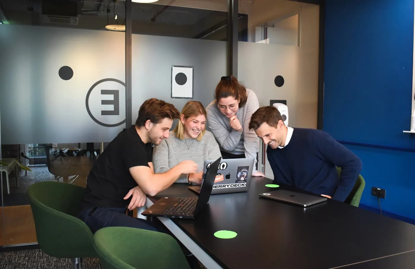 Colleagues working together at a shared desk